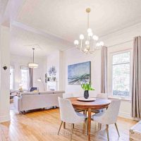Living room with hardwood floors, original mouldings, and fireplace