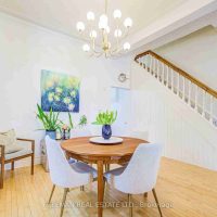 Open-concept dining area with hardwood floors and natural light